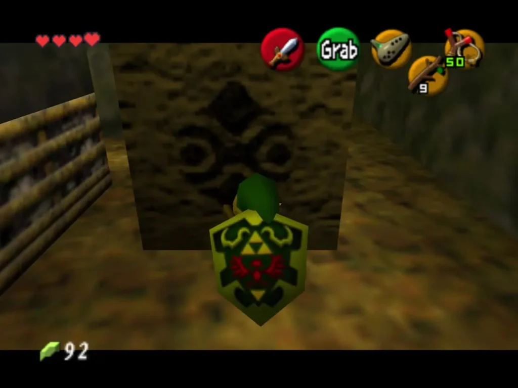 Link pushing against a carved stone block with the Grab prompt showing