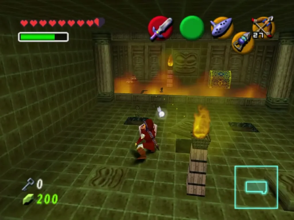 Link beside a burning torch on wooden crates in the green-tiled room