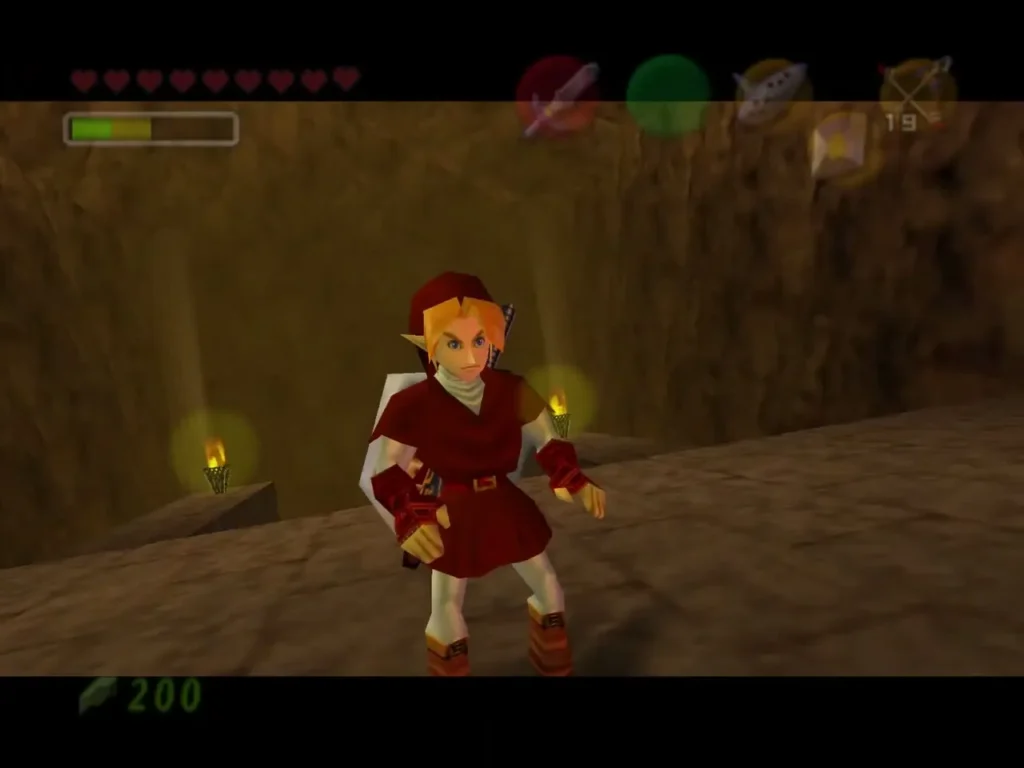 Link stands between two lit torches at the top of the entrance hall stairs