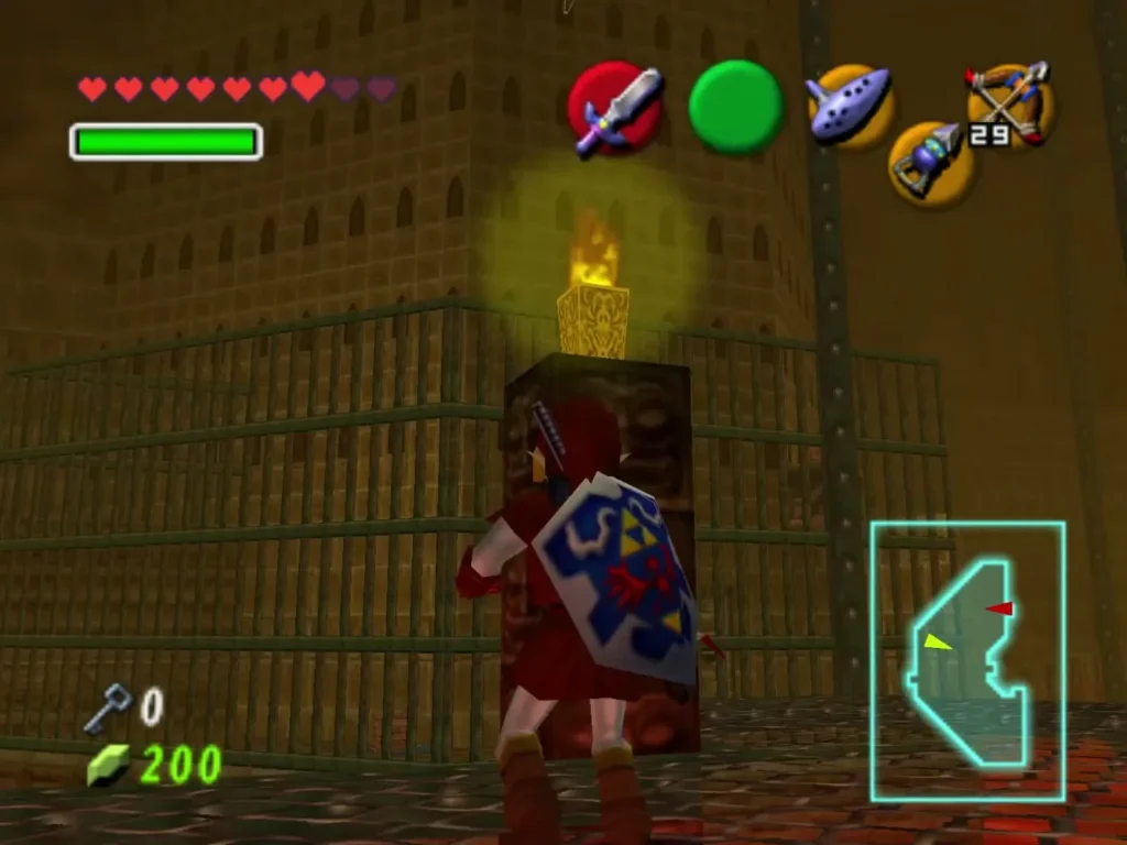 Link beside a carved face block with a lit torch burning above it