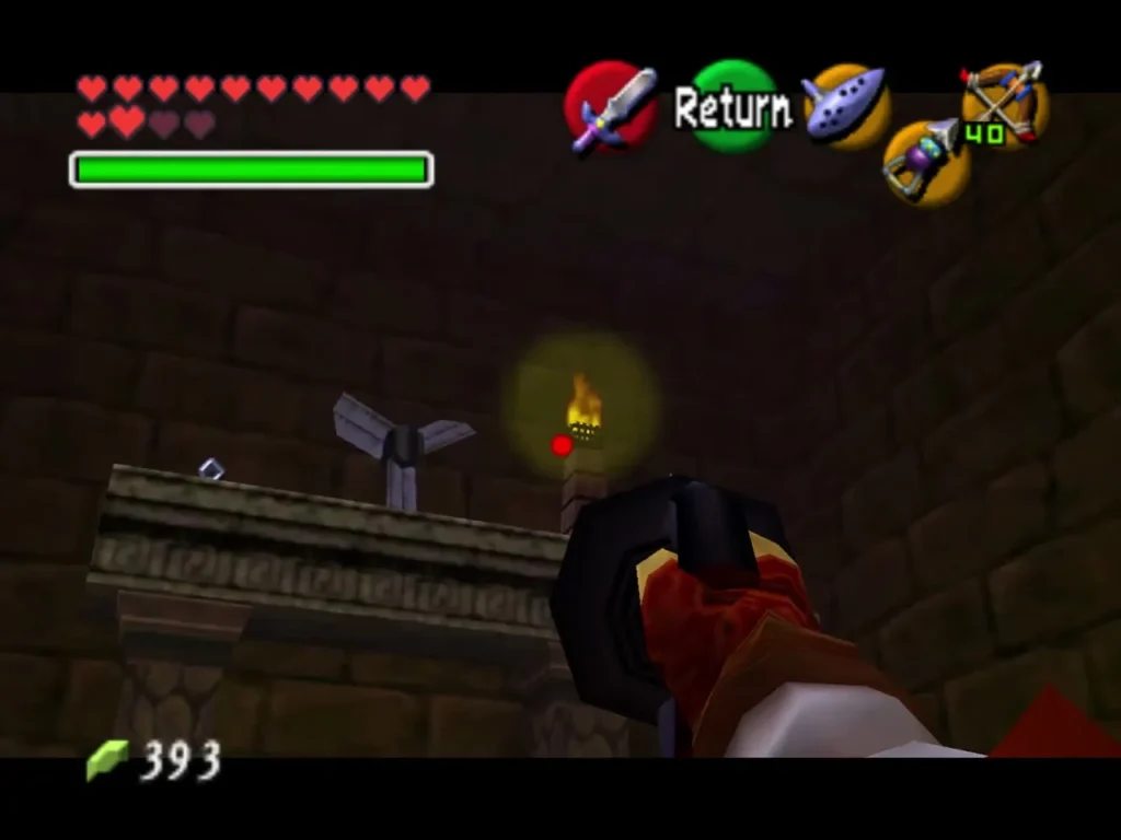 Link aiming the Longshot toward a torch ledge beside a spinning fan over the exit door Link aiming the Longshot toward a torch ledge beside a spinning fan over the exit door