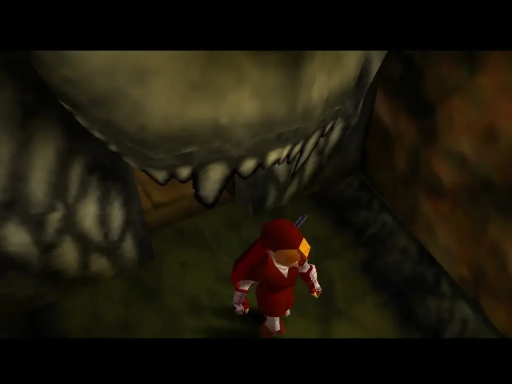 Link standing under a giant stone lion mouth doorway with teeth Link standing under a giant stone lion mouth doorway with teeth