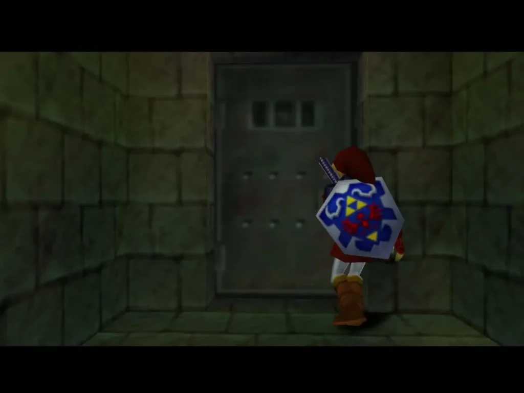 Link walking up to a metal door in a stone hall of the Shadow Temple