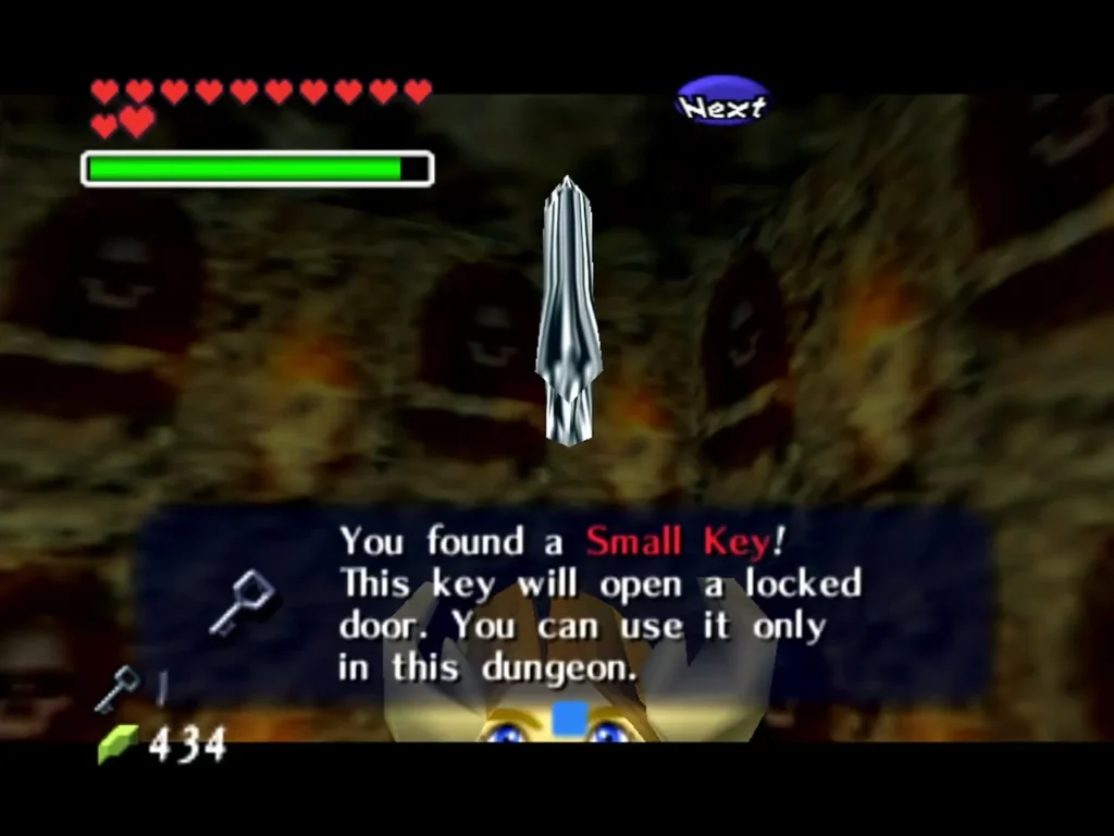 Link holds up a Small Key with the You found a Small Key message box in the Bottom of the Well
