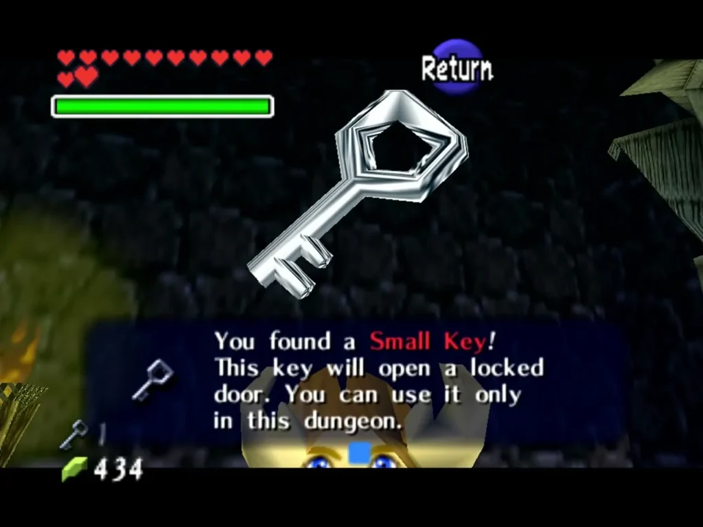 Link holding up a Small Key with the 'You found a Small Key!' box in the Bottom of the Well