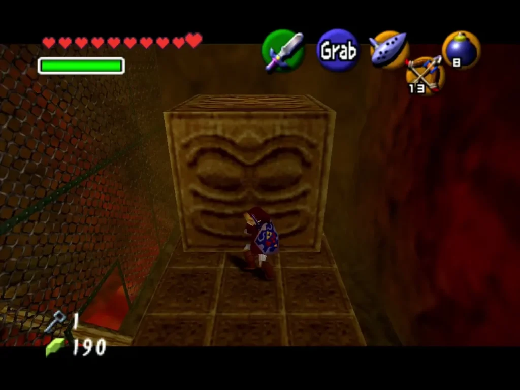 Link beside a carved face block before pushing it onto the lava geyser Link beside a carved face block before pushing it onto the lava geyser