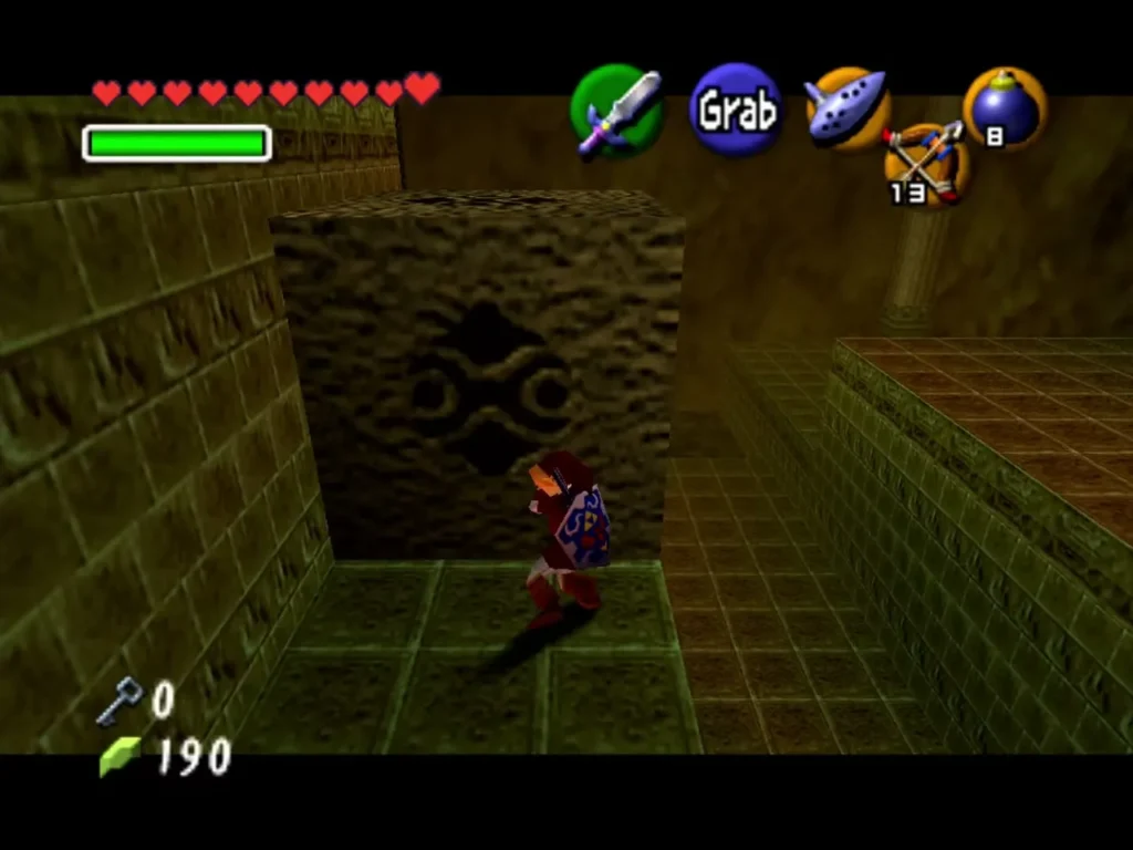 Link grabbing the large stone block beside a ledge in the Fire Temple Link grabbing the large stone block beside a ledge in the Fire Temple