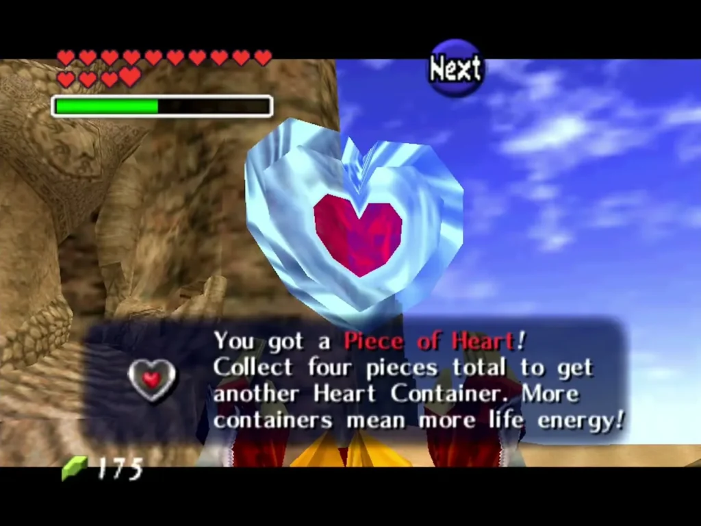 Link holds up a Piece of Heart with its full message box beside a sandstone cliff Link holds up a Piece of Heart with its full message box beside a sandstone cliff