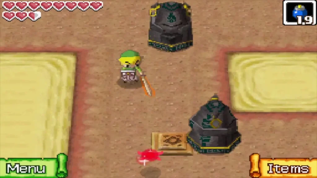 Link standing between two stone Armos statues in a sandy Goron Temple room Link standing between two stone Armos statues in a sandy Goron Temple room