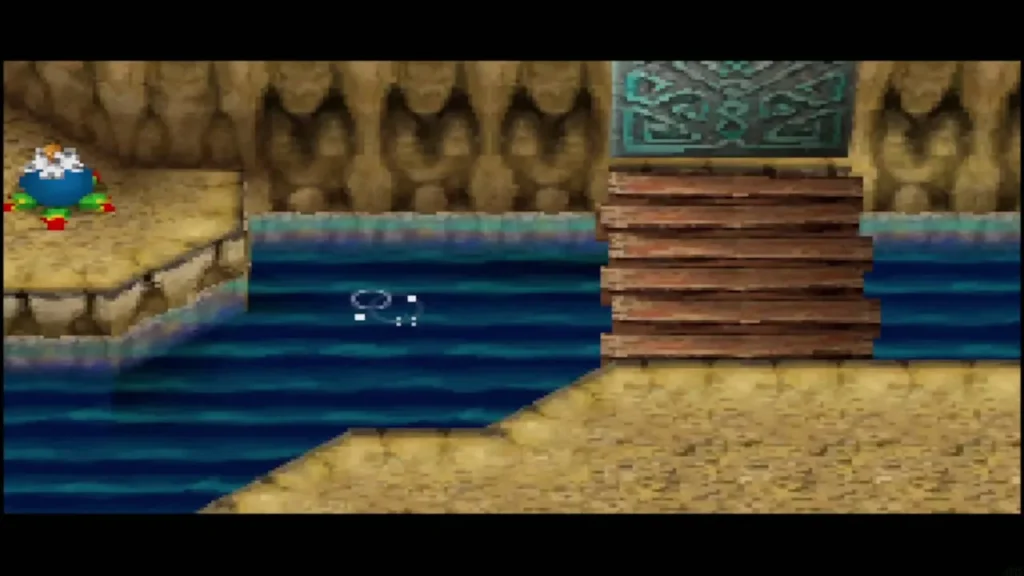 A wooden bridge leads across the water toward a carved door in the cave A wooden bridge leads across the water toward a carved door in the cave