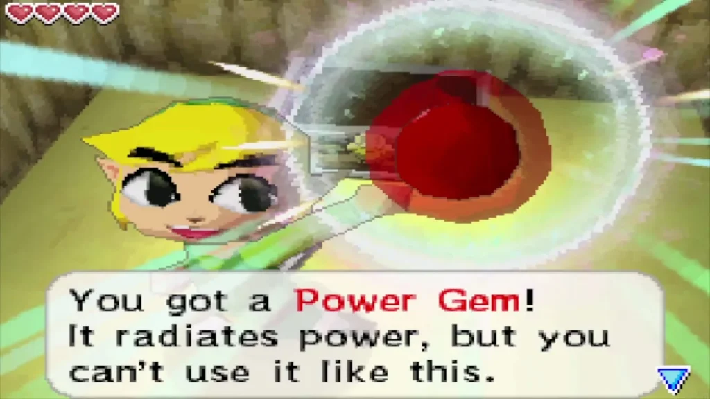 Link holds up a Power Gem with its message box in the cave Link holds up a Power Gem with its message box in the cave