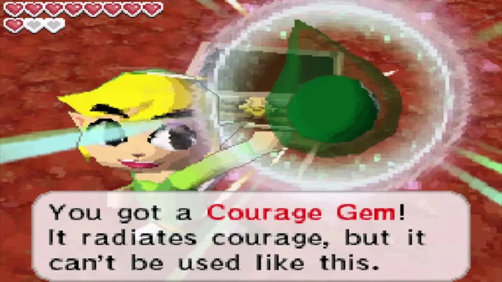 Link holding up a Courage Gem with the item message box Link holding up a Courage Gem with the item message box
