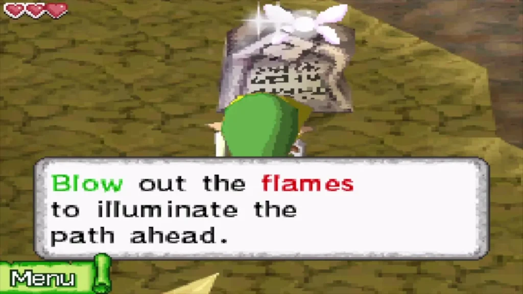 A stone tablet telling Link to blow out the flames to illuminate the path A stone tablet telling Link to blow out the flames to illuminate the path