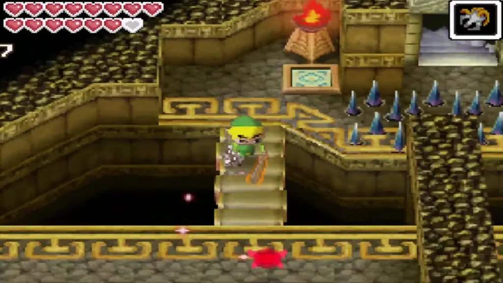 Link on a stairway beside a lit torch, with floor spikes nearby Link on a stairway beside a lit torch, with floor spikes nearby