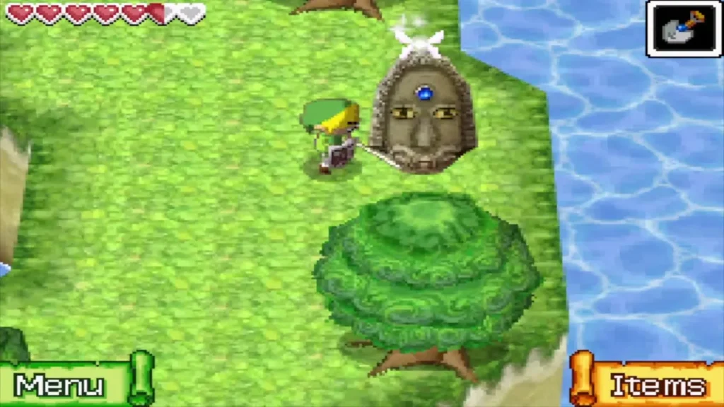 Link beside the stone statue at the water's edge east of the gate Link beside the stone statue at the water's edge east of the gate