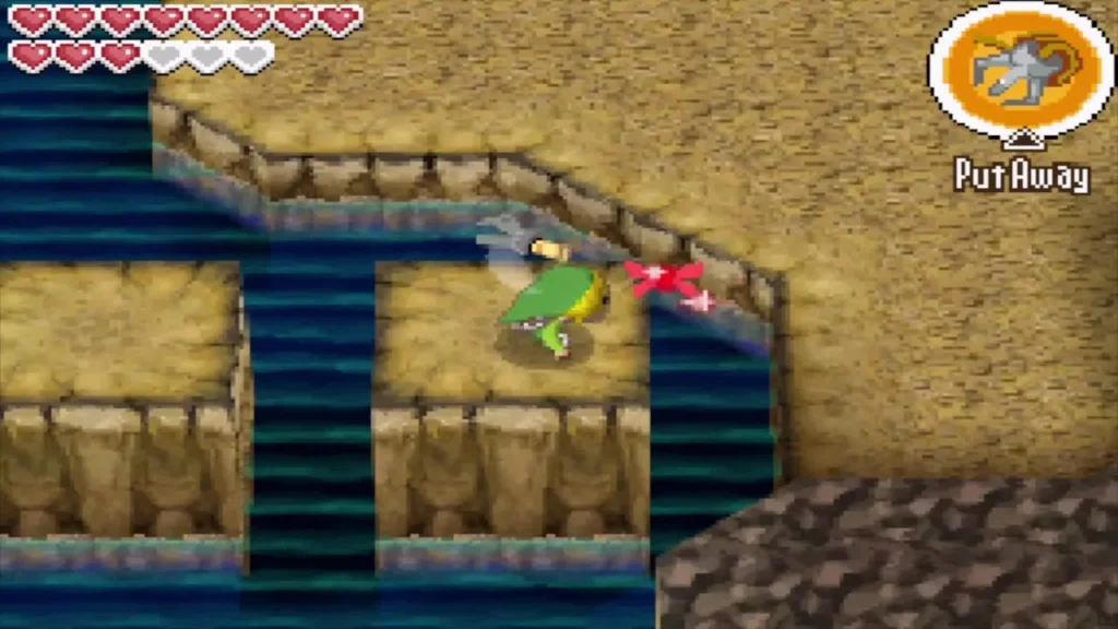 Link stands on a ledge in the Molida cavern with the Grappling Hook equipped Link stands on a ledge in the Molida cavern with the Grappling Hook equipped