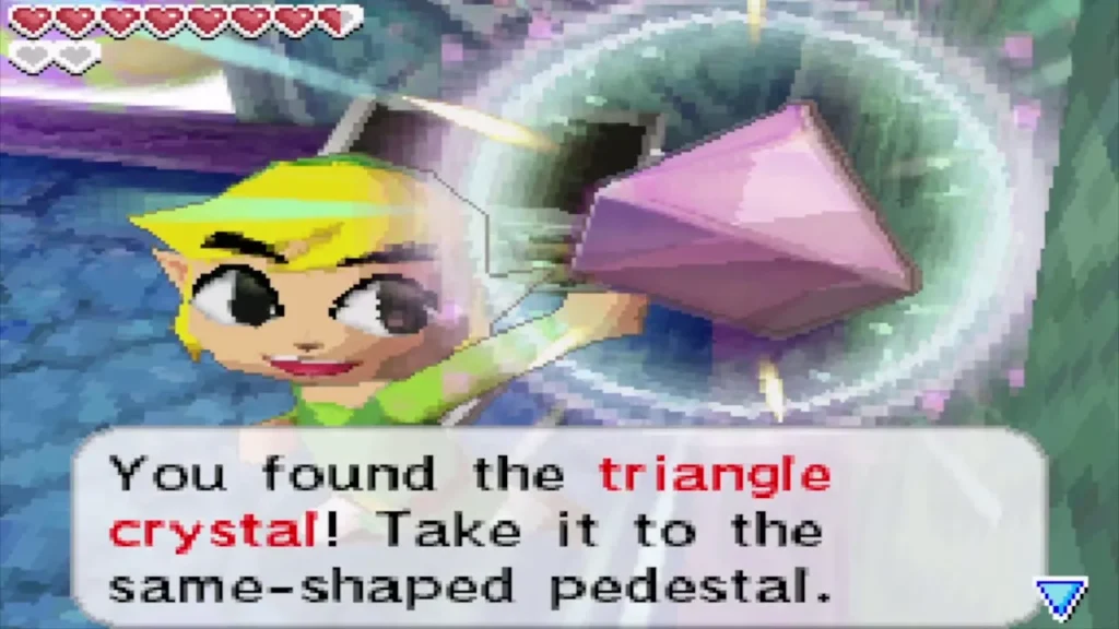 Link holding up the triangle crystal with its message from the B9 chest Link holding up the triangle crystal with its message from the B9 chest