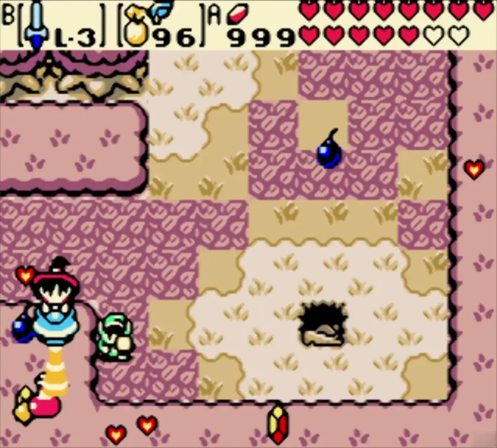 Maple beside a heart, rupees and a bomb on the pink cave floor Maple beside a heart, rupees and a bomb on the pink cave floor