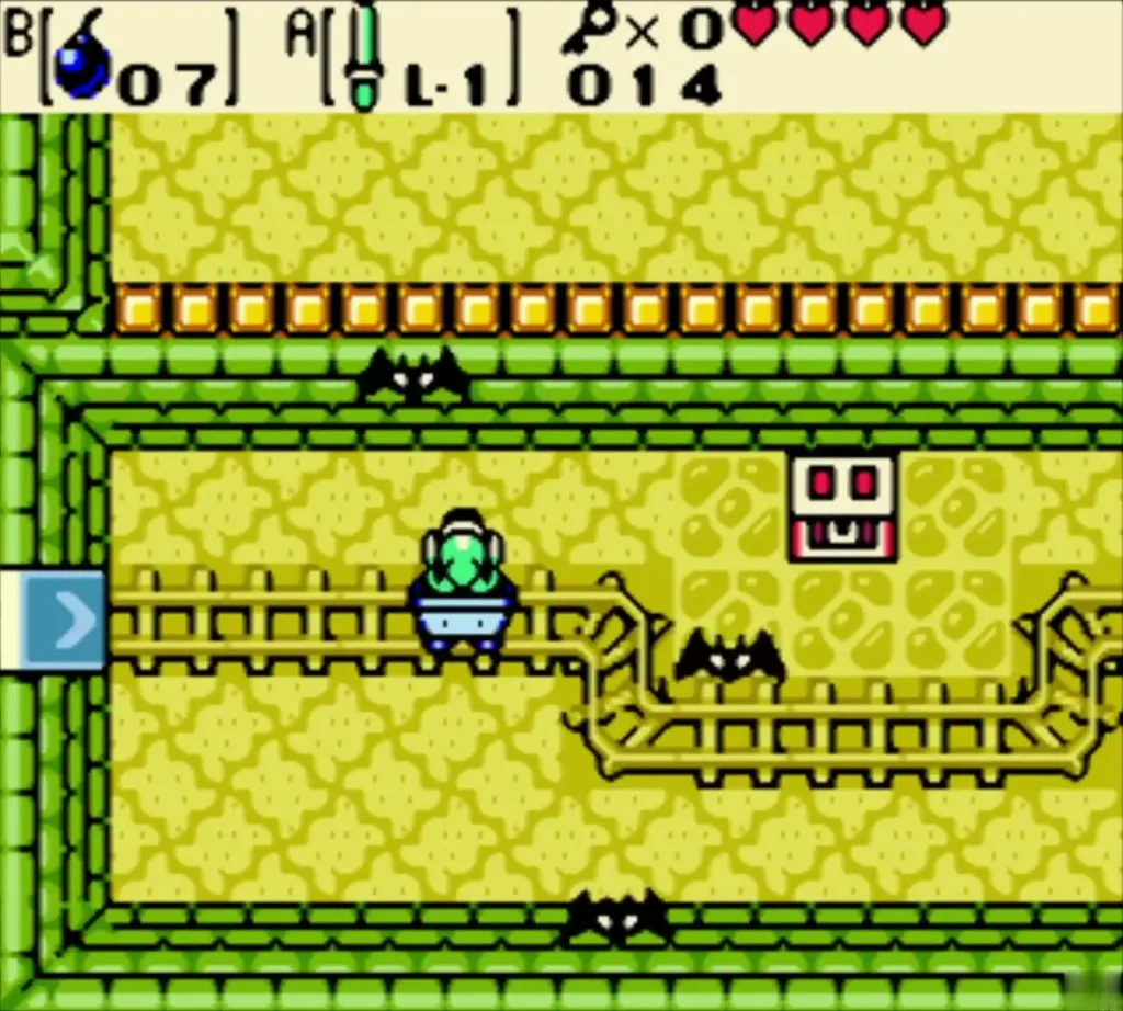 Link riding the minecart east past Keese toward the chest Link riding the minecart east past Keese toward the chest
