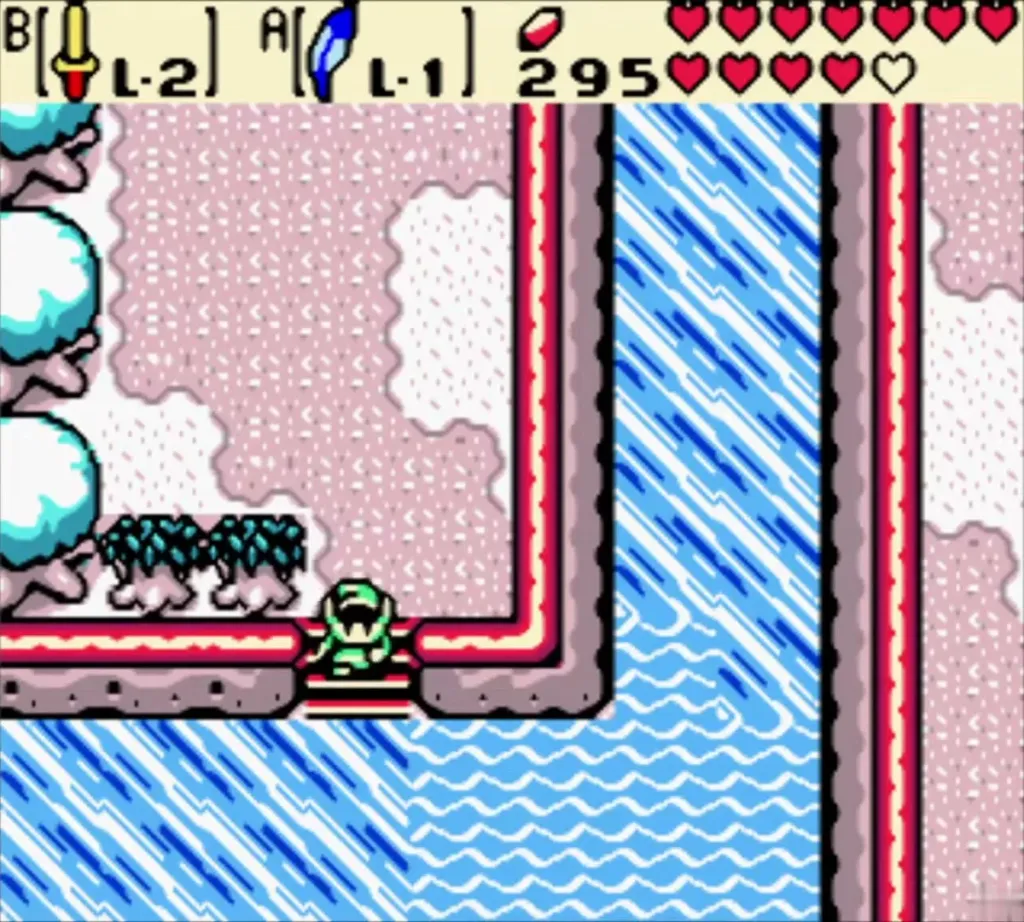 Link on a snowy path beside a frozen lake outside Unicorn's Cave