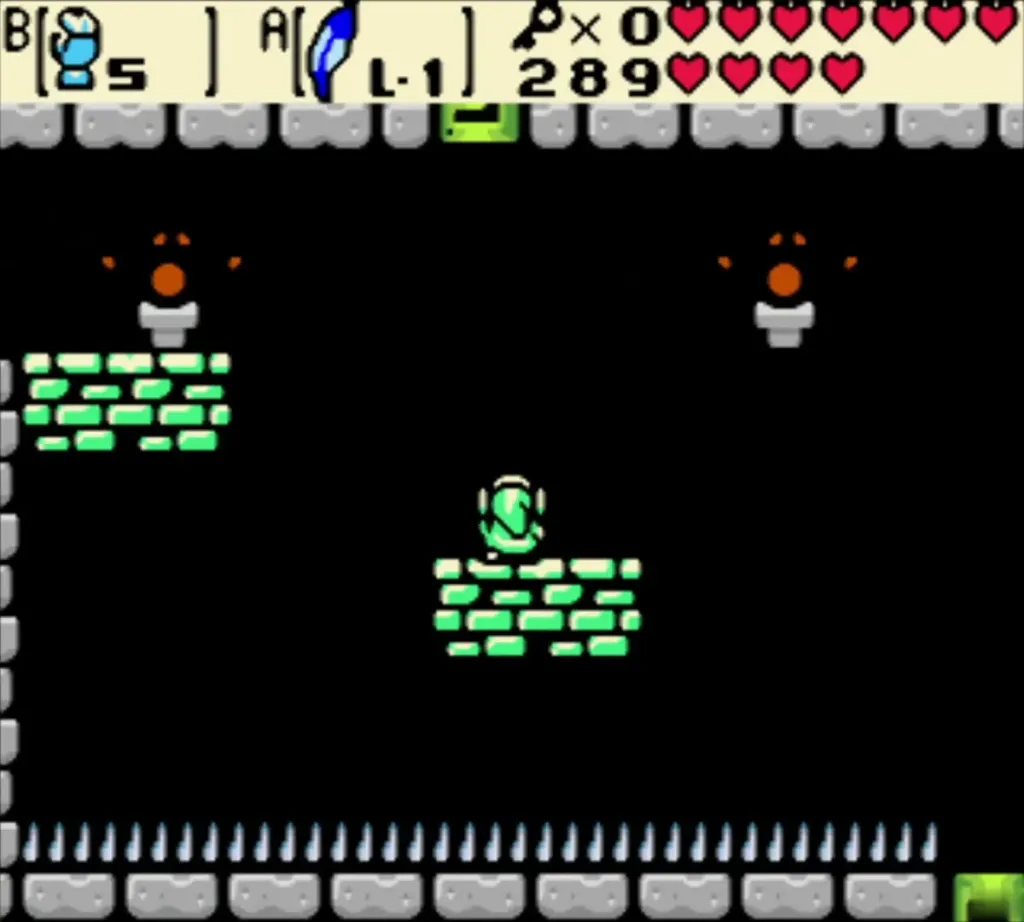 Link standing on green floating platforms above a row of spikes