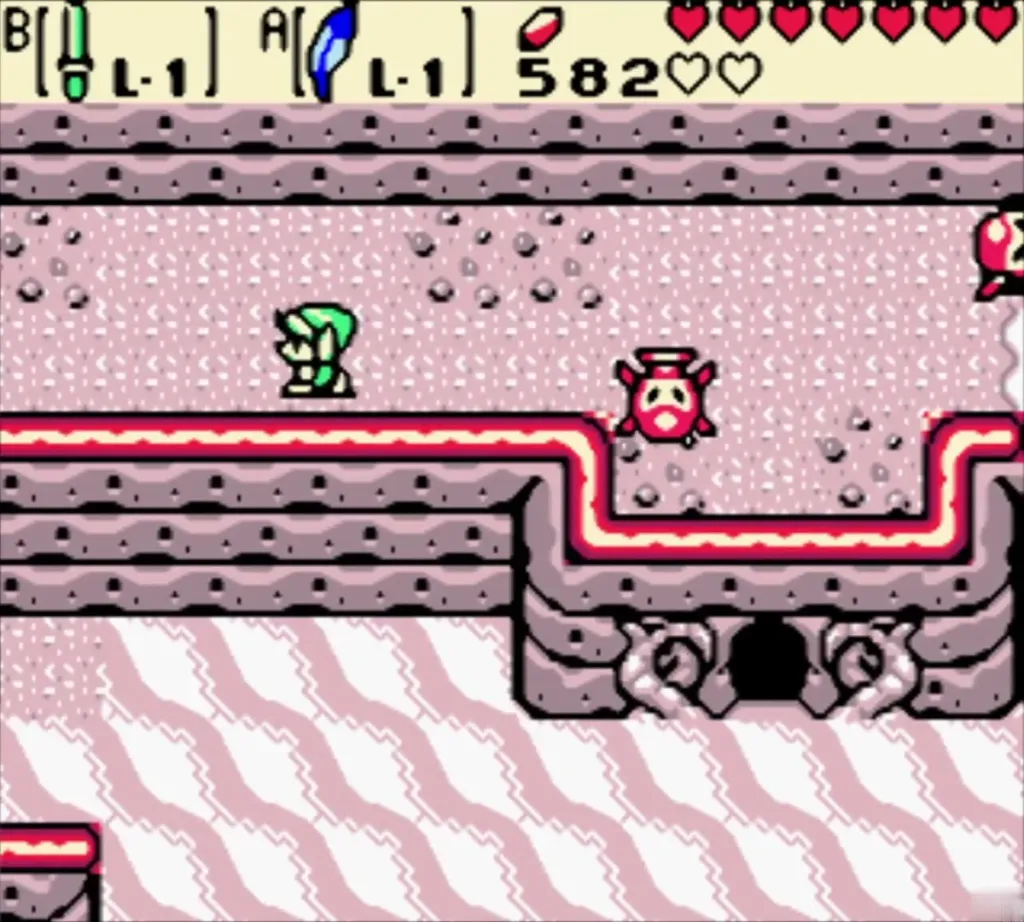 Link on the beach with an Octorok near the cave mouth in the cliff Link on the beach with an Octorok near the cave mouth in the cliff
