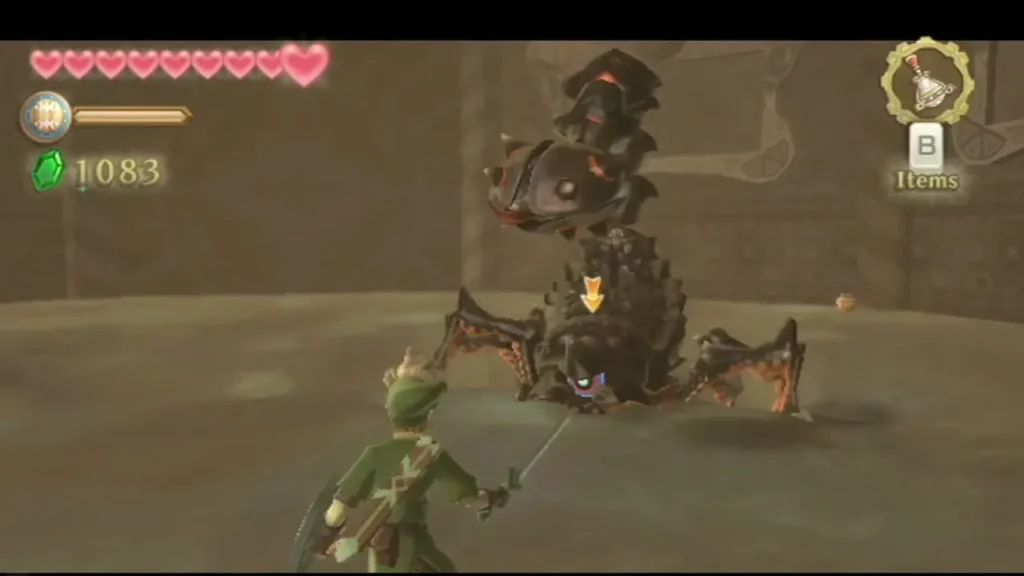 Moldarach rears up over the arena with its eye and stinger raised while Link stands with his sword ready. Moldarach rears up over the arena with its eye and stinger raised while Link stands with his sword ready.