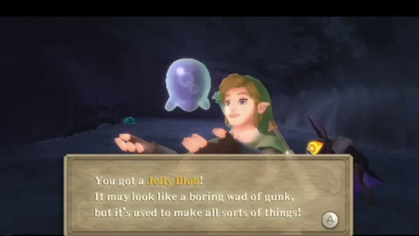 Link holds up a Jelly Blob, a glowing blue glob, under the full message box that says it is used to make things. Link holds up a Jelly Blob, a glowing blue glob, under the full message box that says it is used to make things.