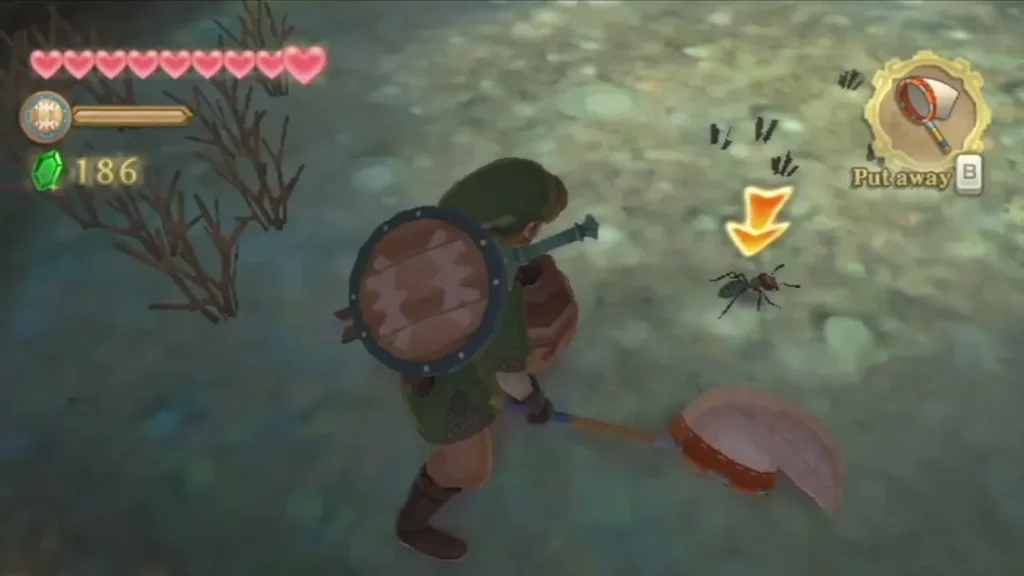 Link lowers a Bug Net toward a Lanayru Ant on the ground, with a Put away prompt in the corner. Link lowers a Bug Net toward a Lanayru Ant on the ground, with a Put away prompt in the corner.