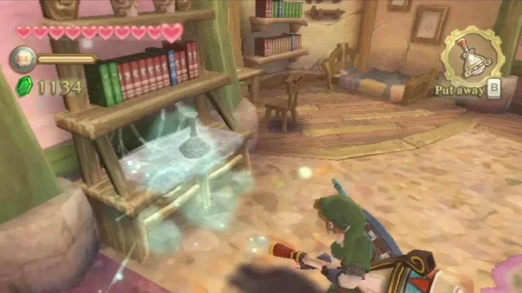 Link aims the Gust Bellows at a shelf and blows a cloud of dust off the furniture in a pink room. Link aims the Gust Bellows at a shelf and blows a cloud of dust off the furniture in a pink room.