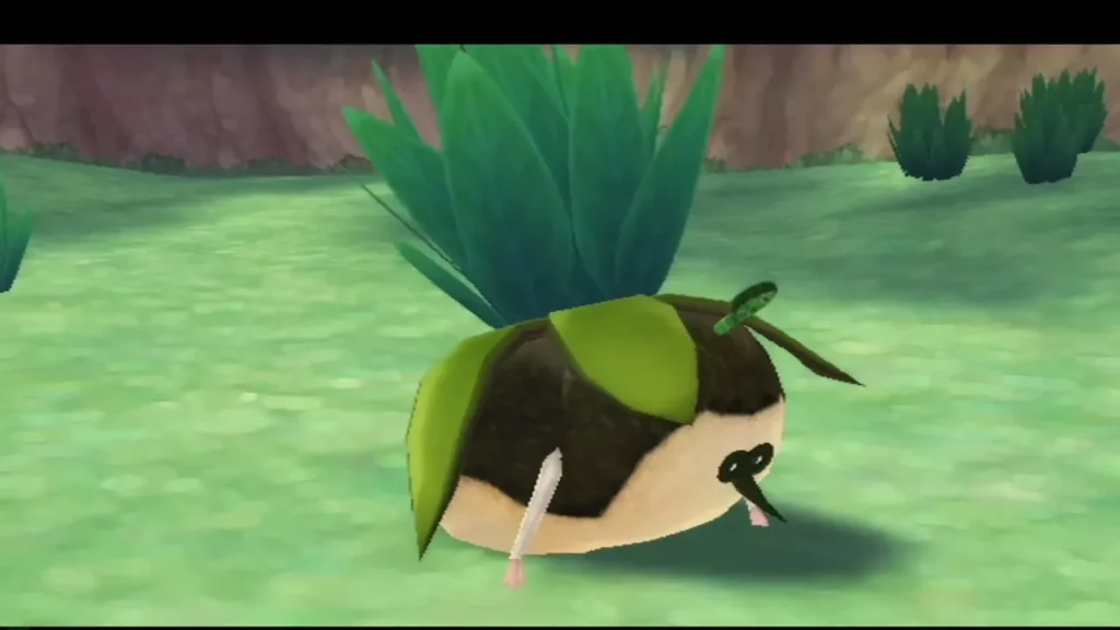 A round Kikwi with a leafy green crest crouches in the grass, looking like a plant bush. A round Kikwi with a leafy green crest crouches in the grass, looking like a plant bush.