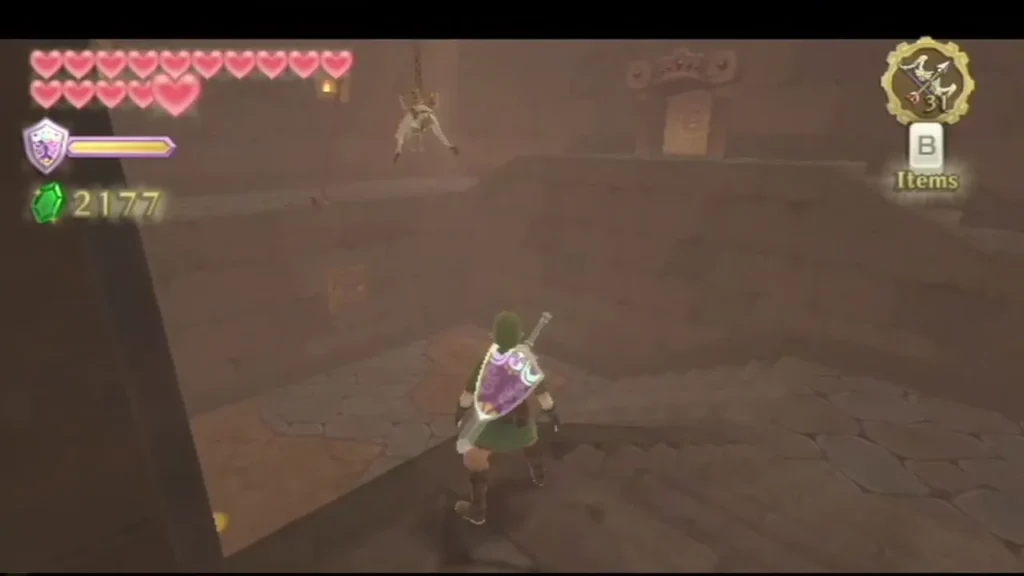 A Mogma hangs by a rope in the Fire Sanctuary while Link climbs the stairs below. A Mogma hangs by a rope in the Fire Sanctuary while Link climbs the stairs below.