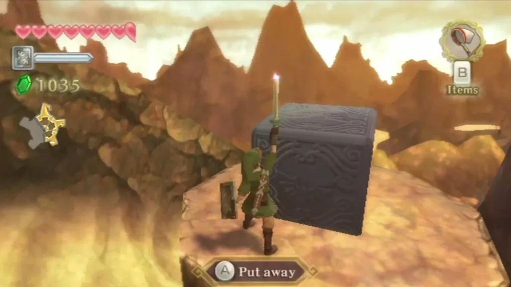 Link raises the Goddess Sword toward a grey stone cube on a round sand-rock ledge above the sand slide