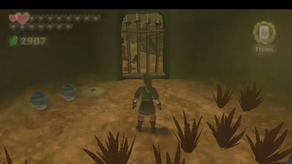 Link stands in a dim cell with a barred gate, and a few pots sit on the floor beside him.
