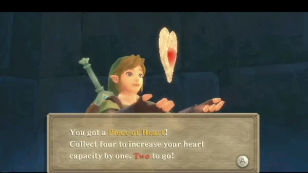 In a dark ruin, Link holds up a Piece of Heart; the box says two more pieces fill the next heart. In a dark ruin, Link holds up a Piece of Heart; the box says two more pieces fill the next heart.