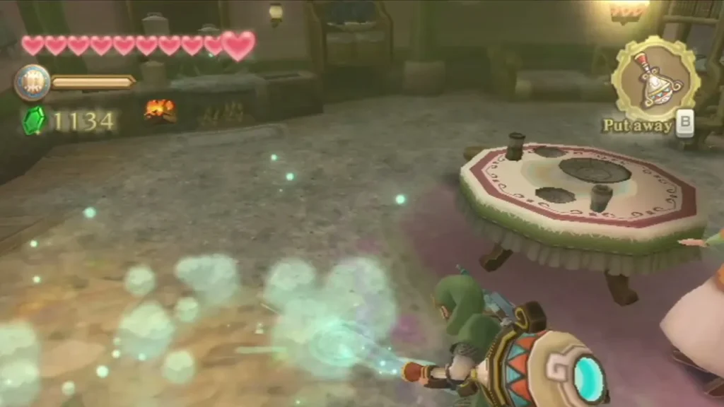 Link blows a cyan gust across the floor of a Skyloft house with the Gust Bellows, scattering dust past a round table. Link blows a cyan gust across the floor of a Skyloft house with the Gust Bellows, scattering dust past a round table.