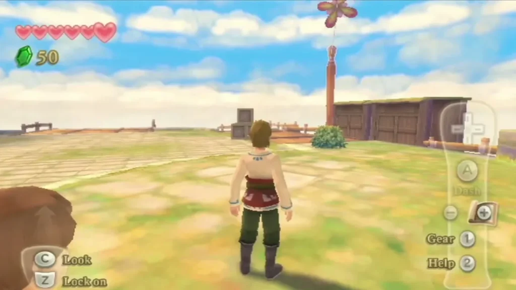 Link stands on an open Skyloft plaza past wooden sheds and a tall pole with a flower on top. Link stands on an open Skyloft plaza past wooden sheds and a tall pole with a flower on top.