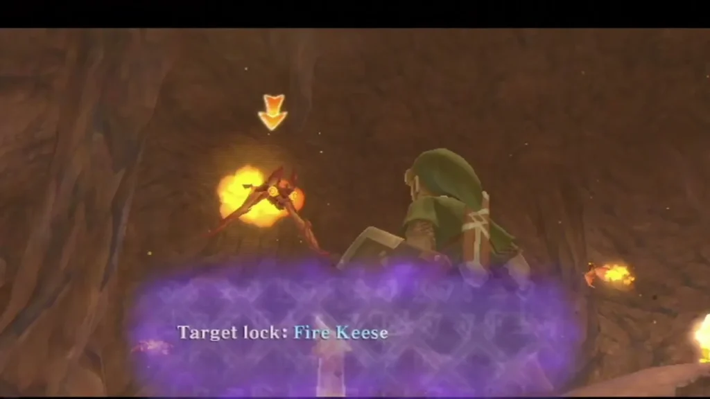 Link faces a Fire Keese in a dark cave, with the target lock label across the bottom. Link faces a Fire Keese in a dark cave, with the target lock label across the bottom.