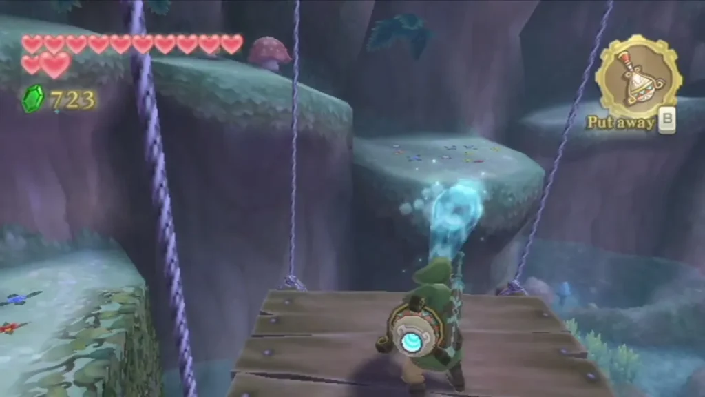 Link stands on a hanging wooden platform inside the Great Tree while a blue gust blows from a fan nearby.