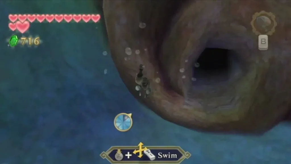 Link swims toward a dark tunnel in the underwater trunk of the Great Tree, with air bubbles rising around him.