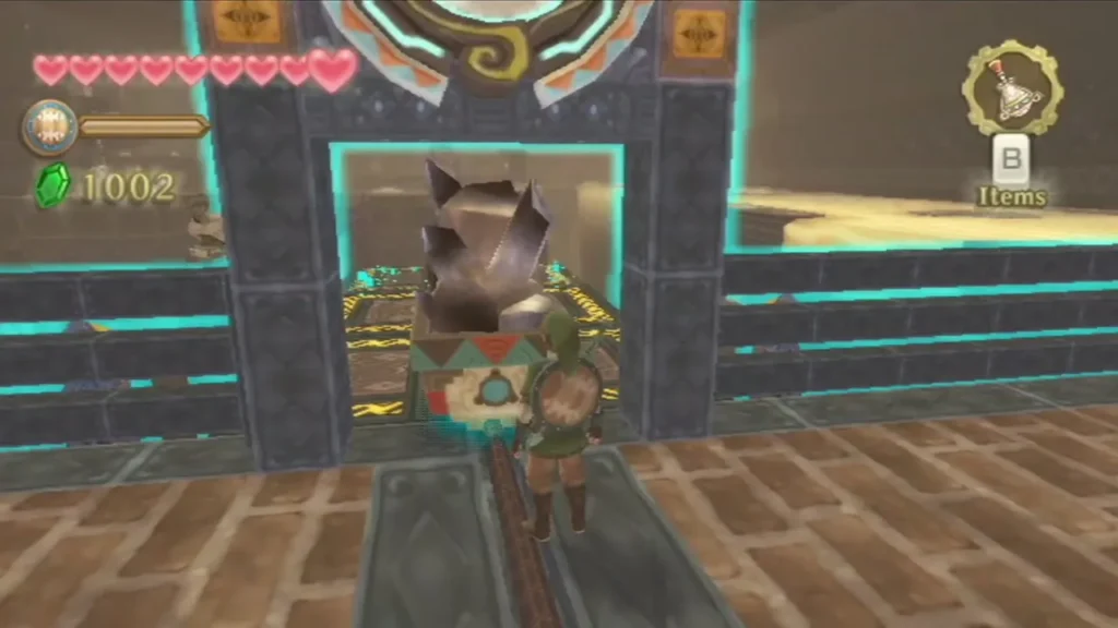 Link stands at a rail cart carrying a glowing blue Timeshift Stone in front of a gate. Link stands at a rail cart carrying a glowing blue Timeshift Stone in front of a gate.