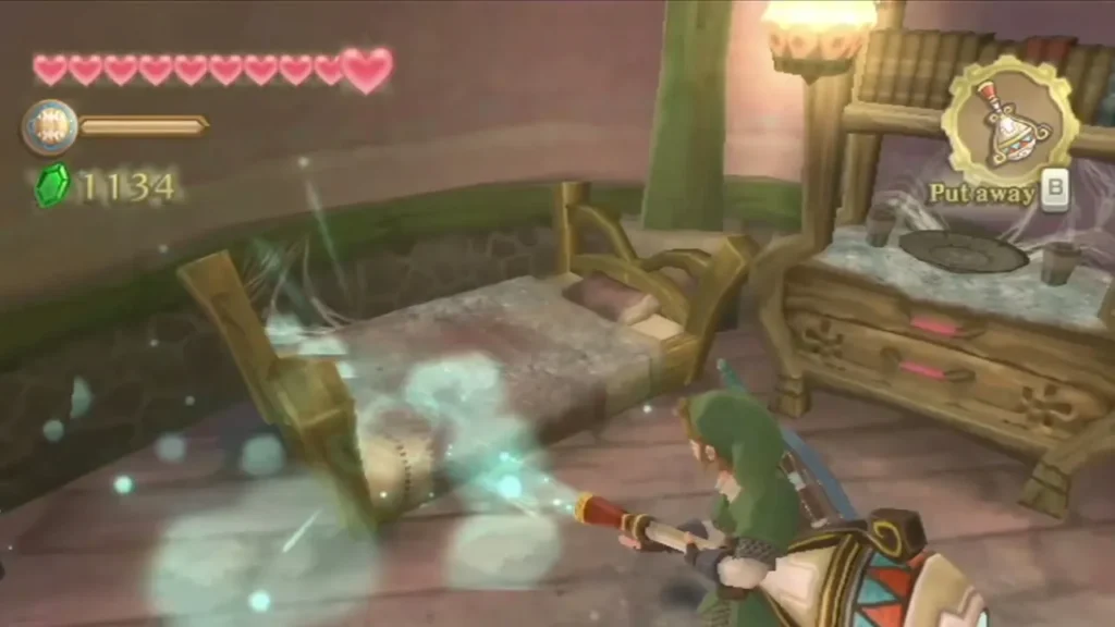 Link aims the Gust Bellows at a dusty bed and dresser, blowing a cloud of dust away Link aims the Gust Bellows at a dusty bed and dresser, blowing a cloud of dust away