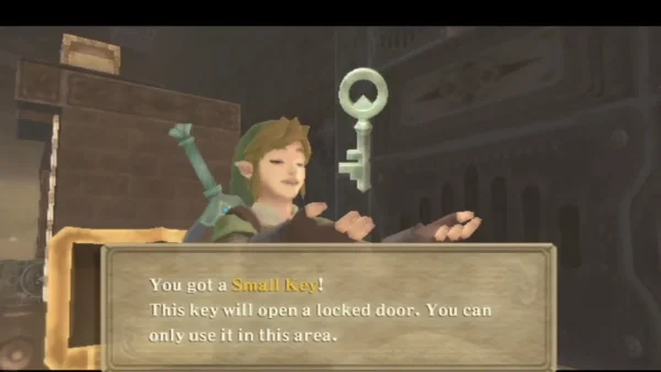 Link holds up a Small Key, with its box saying it opens a locked door in this area. Link holds up a Small Key, with its box saying it opens a locked door in this area.