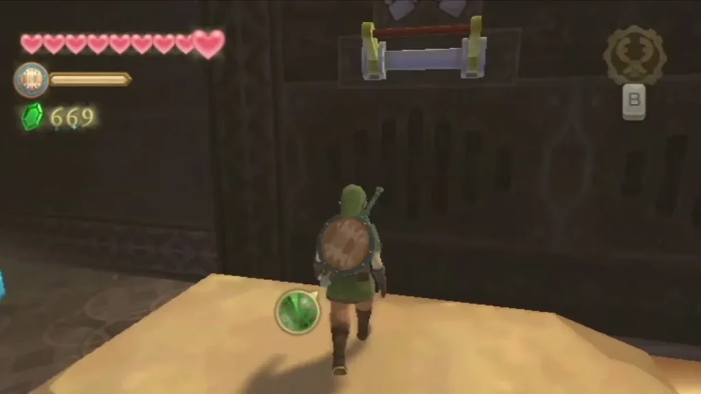 Link stands on a sand ledge beneath a wall switch set above a barred door in the Mining Facility. Link stands on a sand ledge beneath a wall switch set above a barred door in the Mining Facility.