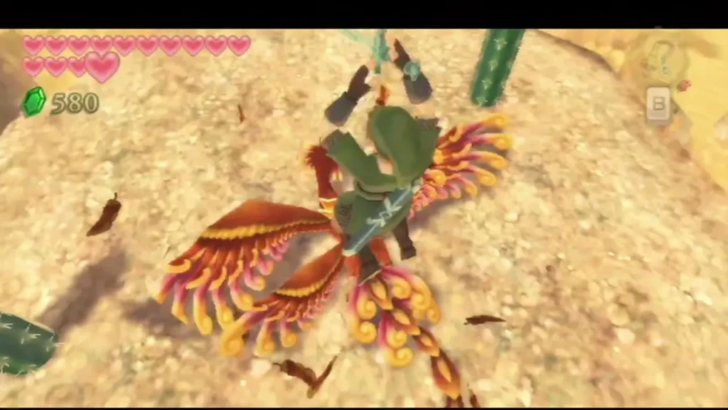 Link fights a red-gold fire bird on the sand with his sword, its flaming feathers flying around him. Link fights a red-gold fire bird on the sand with his sword, its flaming feathers flying around him.