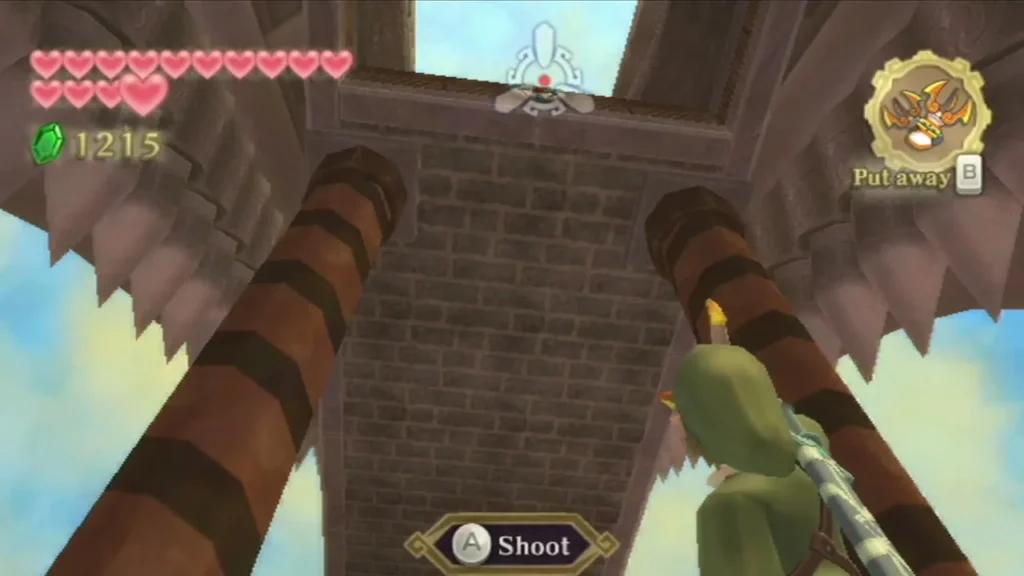 Link aims at a target high on a striped pillar outside the Pirate Stronghold, with the Shoot prompt showing. Link aims at a target high on a striped pillar outside the Pirate Stronghold, with the Shoot prompt showing.
