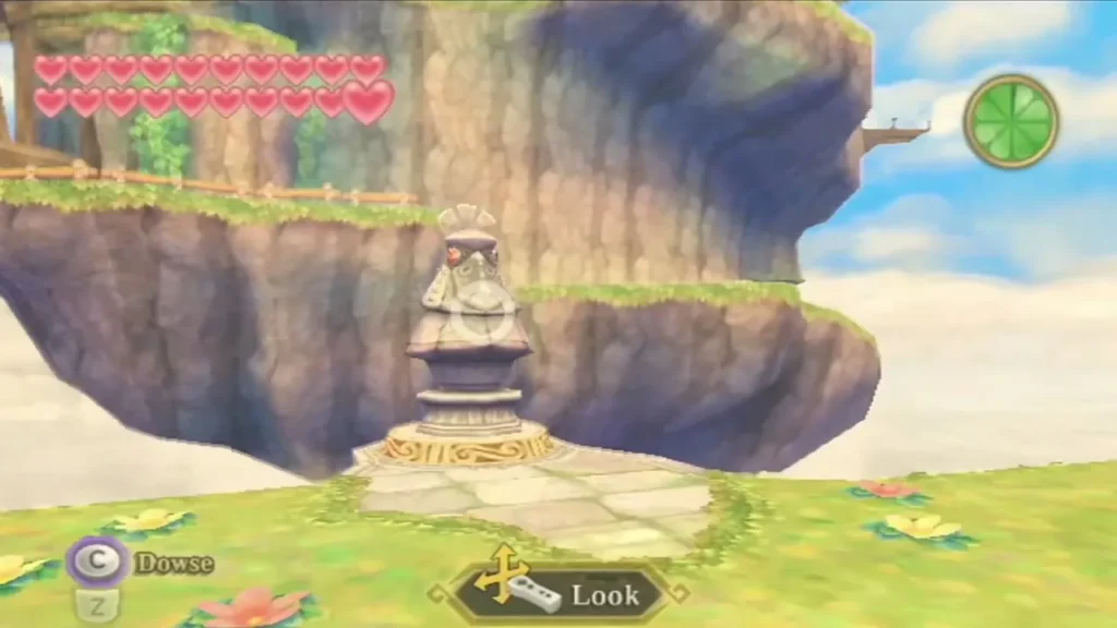 A bird statue stands on a grassy ledge beside a lake, with a Look prompt over it.