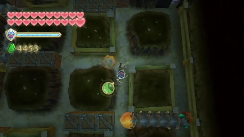 Link digs through the underground pit maze while a Moldorm crawls along the path beside him.