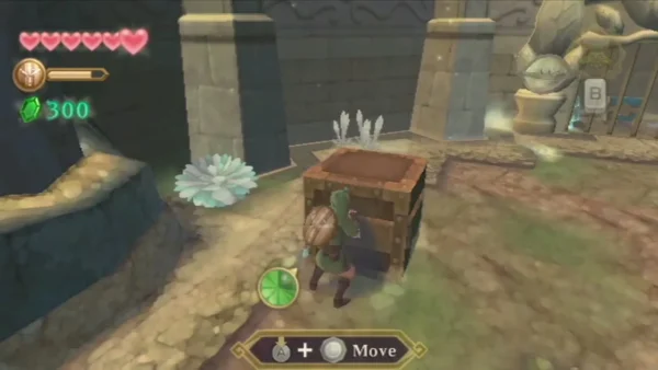 Link pushes a wooden crate across the stone floor, with the Move prompt on screen, beside an ice-crystal ledge. Link pushes a wooden crate across the stone floor, with the Move prompt on screen, beside an ice-crystal ledge.