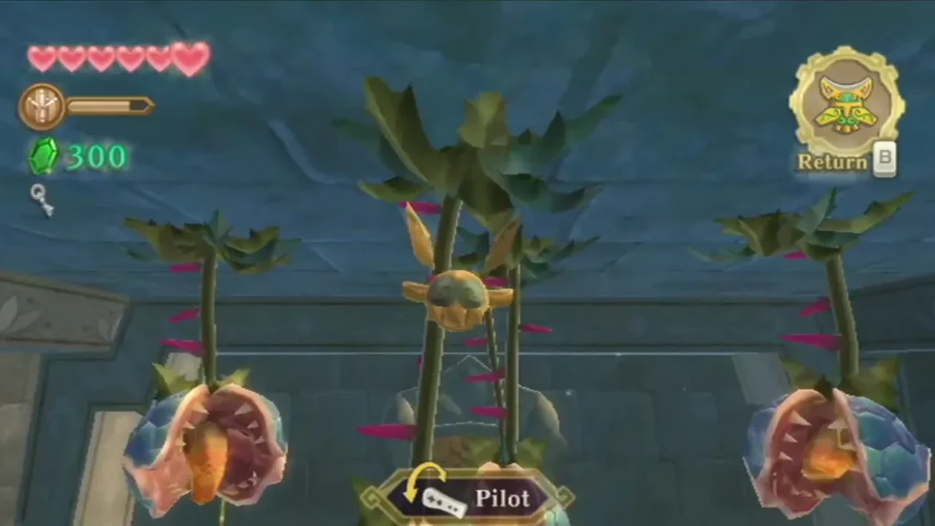Large Deku Baba plants hang in a blue stone hall, with the Beetle in the air and the Pilot prompt on screen. Large Deku Baba plants hang in a blue stone hall, with the Beetle in the air and the Pilot prompt on screen.